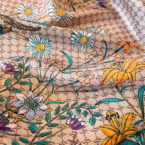 Macro shot of vintage floral print fabric with monogram pattern and colorful flowers