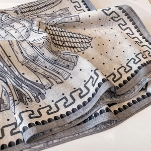 Elegant silk scarf with classical geometric patterns and soft artistic drape on white base