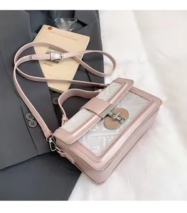 Detail of pink vintage crossbody bag showing jacquard texture and metallic lock buckle