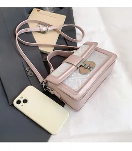 Detailed view of small pink square bag with geometric texture and silver clasp closure