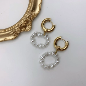Vintage gold hoop earrings with irregular baroque pearl pendants on white background