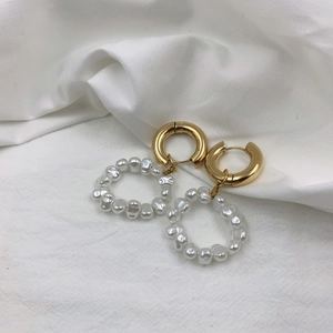 Detail of vintage gold hoop earrings with white baroque pearl woven pendant drops