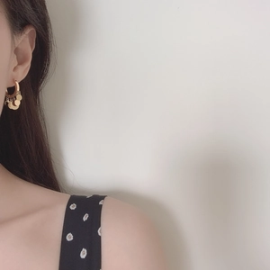 French style gold hoop earrings with polished round disc charms on minimalist female model