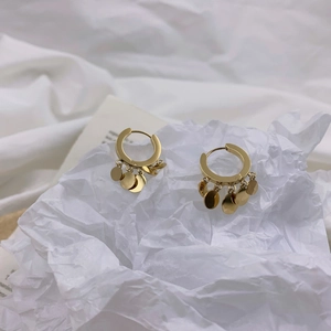 Minimalist gold hoop earrings with multiple hanging disc pendants on white background