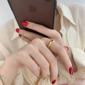 Polished gold titanium steel signet ring for women worn on index finger in minimalist style