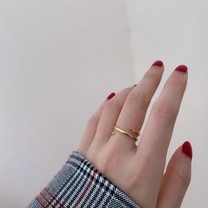 Detail view of 18k gold plated multi-layer wrap ring worn on a finger for styling