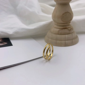 Minimalist 18k gold plated titanium steel double layer spiral ring in a lifestyle setting