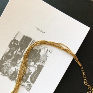Detail of layered gold snake bone chain with lobster clasp and extension structure
