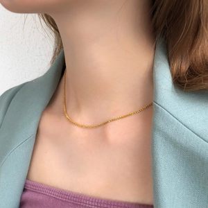 Minimalist gold snowflake choker necklace worn on model for a trendy layered look