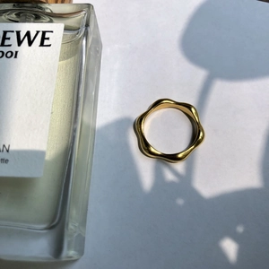 Minimalist gold wavy ring with a stylish irregular ripple design and shiny metallic finish