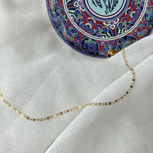 Close-up of minimalist gold-plated link chain necklace with secure lobster clasp detail