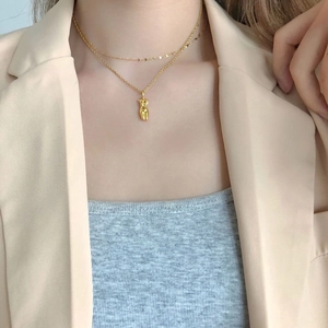 Artistic gold double layer necklace with abstract female body torso sculpture pendant