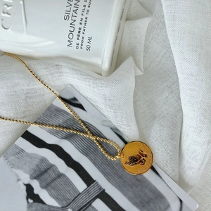 Gold hip hop necklace with engraved praying hands and One Day At A Time slogan
