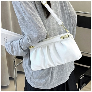 Detail of white ruched cloud bag with lychee texture leather and gold metal clasp
