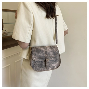 Retro grey marble pattern saddle bag on model with adjustable shoulder strap detail