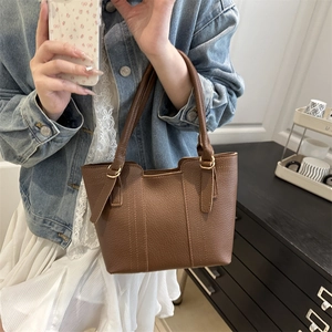 Brown litchi grain vintage bucket bag with gold hardware and stylish handle