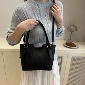 Classic black litchi pattern leather bucket bag with golden hardware and top handles