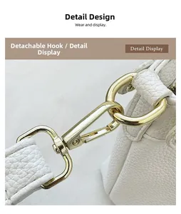 Detail of high-gloss gold detachable hook on white lychee grain leather bag