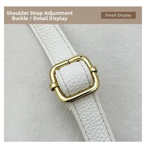 Detail of white lychee grain leather strap with adjustable golden metal square buckle