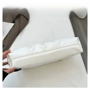 Close-up of precise stitching on premium white lychee grain leather handbag detail