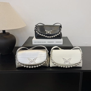 Three beaded handle shoulder bags in black, silver, and white with butterfly buckle