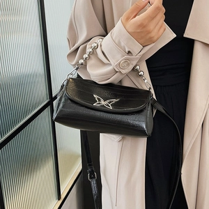 Fashionable black beaded handbag with silver butterfly accent and crocodile texture
