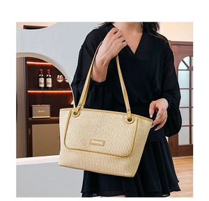 Detail of a woven tote bag featuring yellow leather trim and Fashion & Bags logo patch