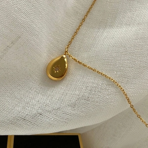 Minimalist gold titanium steel necklace featuring a teardrop pendant with engraved star