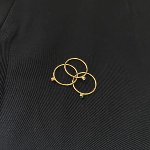 14k gold plated minimalist ring set featuring red and green crystal accents on black fabric