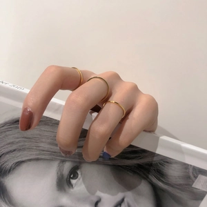 Close-up of a three-piece set of minimalist gold skinny rings for a stylish layered look