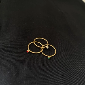 Minimalist 14k gold plated ring set featuring tiny red, green, and clear gemstone inlays