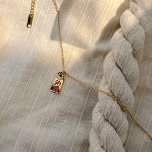 Gold plated stainless steel coin necklace featuring Nafu pendant with red enamel design