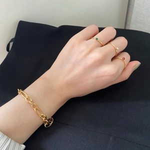 14k gold plated chain bracelet and thin rings set with red and green crystals