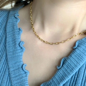 Minimalist gold link chain necklace shown on model for a trendy layered look