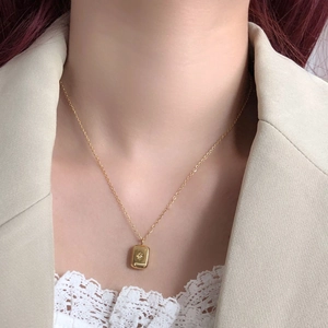 Polished titanium steel necklace with gold star pendant on model neck profile
