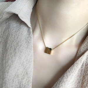 Gold Chinese double happiness pendant necklace on model with square hollow design
