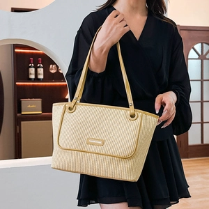 Minimalist woven straw tote bag with yellow leather straps and fashion metal plate