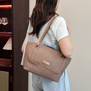 Minimalist brown woven tote bag for women featuring premium leather trim and a large capacity