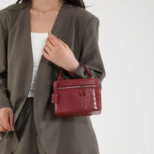 Dark red crocodile pattern handbag with dual zippers and a stylish top handle design