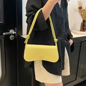 Fashionable bright yellow underarm bag with curved bottom and lychee pattern leather