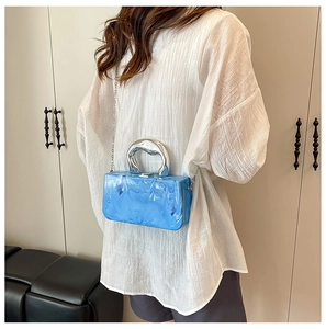 Blaue Marmor Acryl Box Tasche mit silbernen Ringgriffen und Kette an weiblichem Model