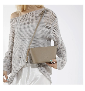 Detail of khaki bucket bag with litchi pattern, metal heart charm and fashion logo