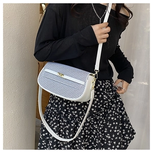 Detail of blue and white plaid crossbody bag with gold twist lock and white leather strap