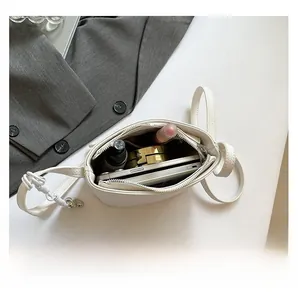 Interior view of white lychee leather shoulder bag showing ample storage capacity