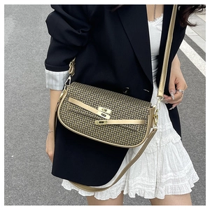 Detailed view of champagne gold woven metallic mesh texture and vintage metal lock closure