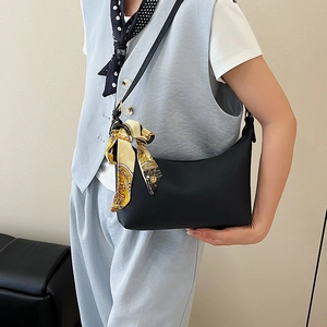 Classic black hobo shoulder bag with decorative yellow silk scarf for stylish women