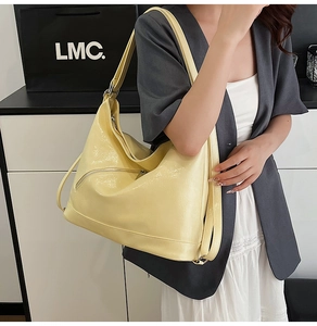 Macro shot of glossy bright yellow faux leather texture and diagonal metal zipper on tote bag