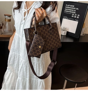 Detail of vintage printed crossbody bag with wide strap and matching small pouch