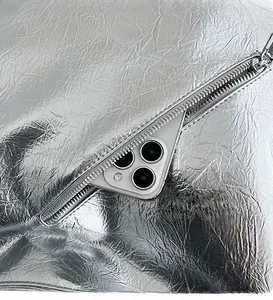 Detail showing high-shine silver wrinkled fabric with a functional front zipper pocket