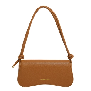 Minimalist brown pebbled leather shoulder bag with knotted strap and gold lettering